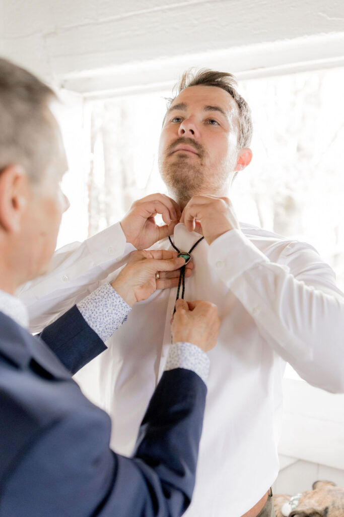 Groom's ties being adjusted