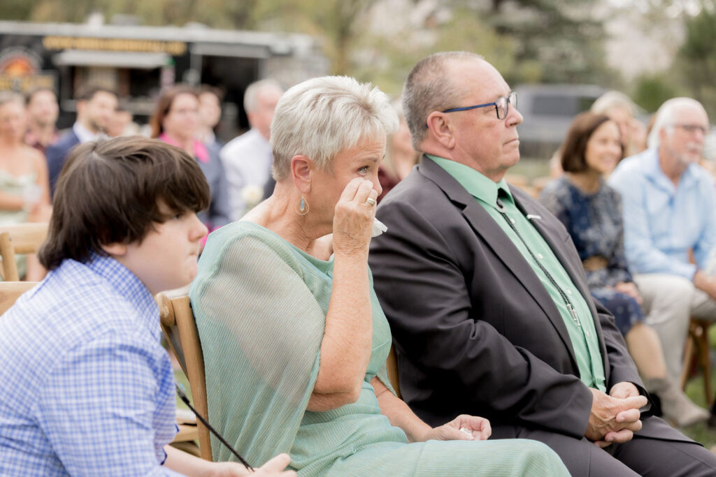 family members wiping away happy tears
