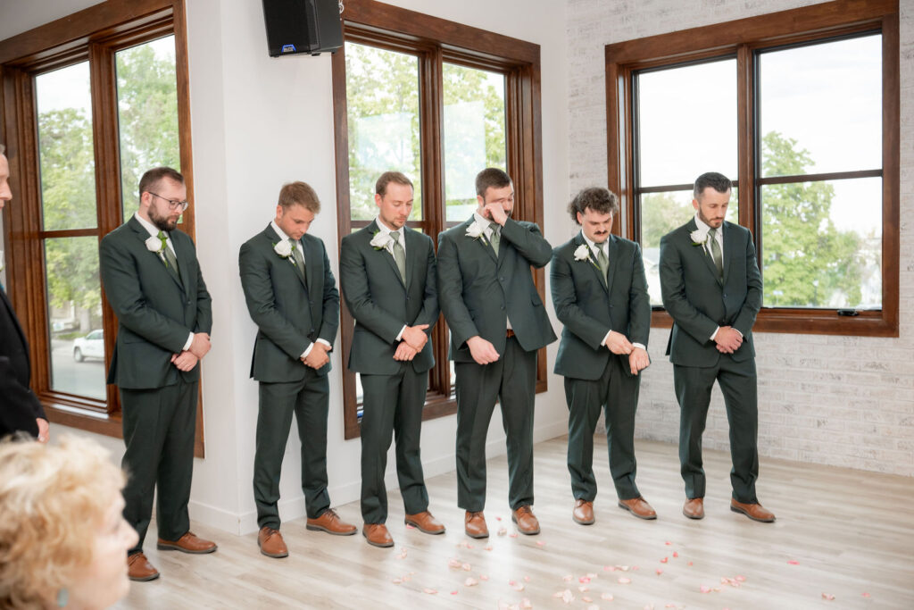 groomsmen matched Ryan in classic green suits